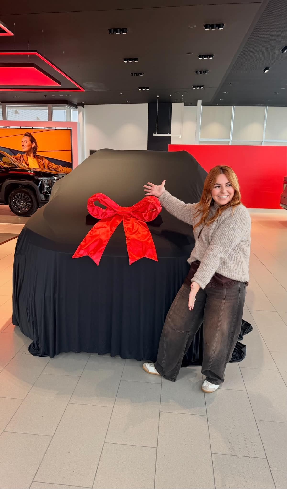 Briganti Money client celebrating her new car at the dealership